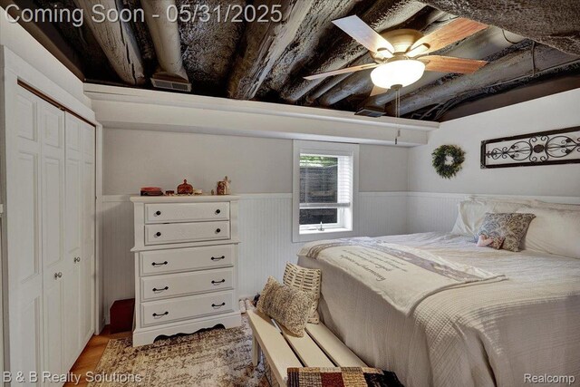 6624 Jefferson Rd, North Branch, MI 48461 - bedroom featuring wainscoting, a closet, a ceiling fan, and wood finished floors