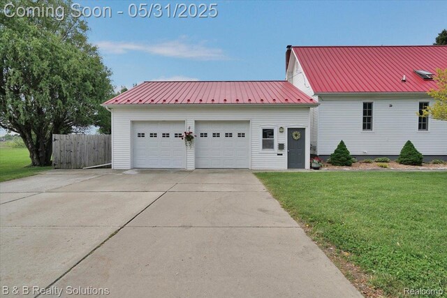6624 Jefferson Rd, North Branch, MI 48461 - view of front of home featuring an outdoor structure, metal roof, a garage, and concrete driveway