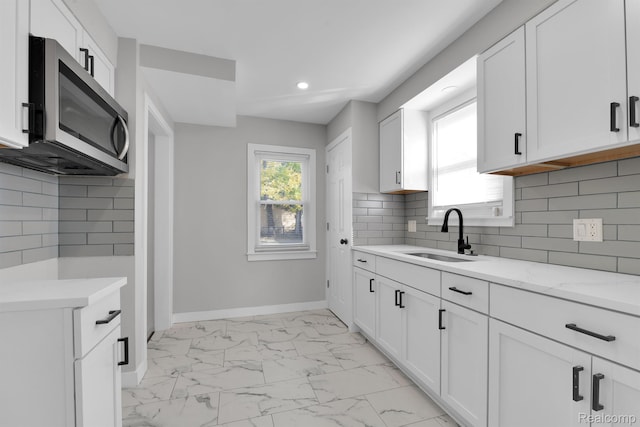 15480 Asbury Park, Detroit, MI 48227 - kitchen with stainless steel microwave, a sink, light marble finish floors, recessed lighting, and baseboards