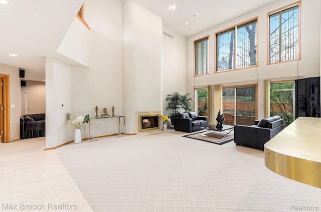5322 Pond Bluff Dr, West Bloomfield, MI 48323 - living room with a towering ceiling, a glass covered fireplace, and recessed lighting