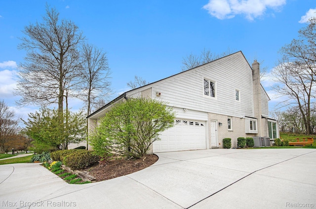 5322 Pond Bluff Dr, West Bloomfield, MI 48323 - view of home's exterior with a chimney, driveway, central AC, and a garage