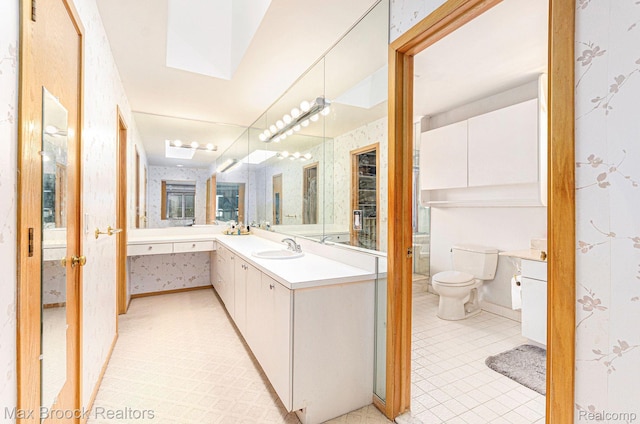 5322 Pond Bluff Dr, West Bloomfield, MI 48323 - full bathroom with wallpapered walls, vanity, toilet, tile patterned floors, and a skylight