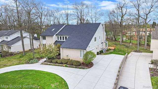 5322 Pond Bluff Dr, West Bloomfield, MI 48323 - view of side of property with a garage, a shingled roof, a lawn, a residential view, and driveway