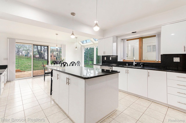 5322 Pond Bluff Dr, West Bloomfield, MI 48323 - kitchen featuring a sink, light tile patterned floors, tasteful backsplash, and white cabinets