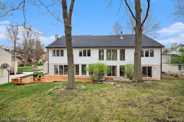 5322 Pond Bluff Dr, West Bloomfield, MI 48323 - rear view of house with a chimney, a lawn, brick siding, and a patio