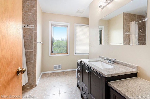 5322 Pond Bluff Dr, West Bloomfield, MI 48323 - bathroom featuring vanity, baseboards, a tile shower, and tile patterned floors