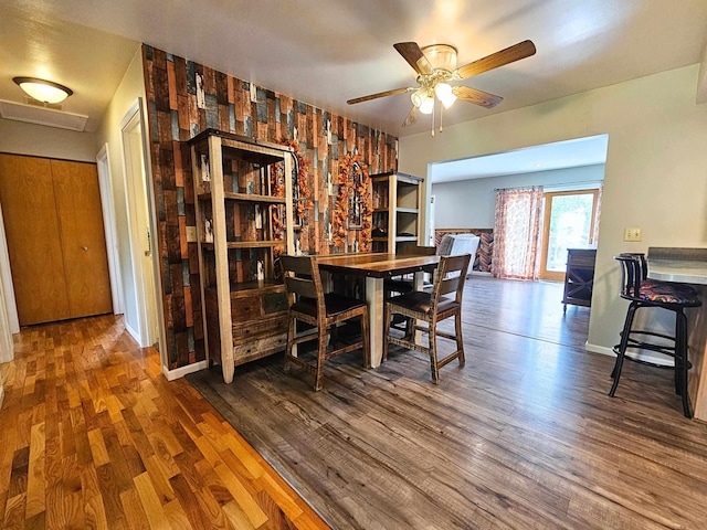10040 S Reese Rd, Birch Run, MI 48415 - dining area with wood finished floors, ceiling fan, baseboards, an accent wall, and wallpapered walls
