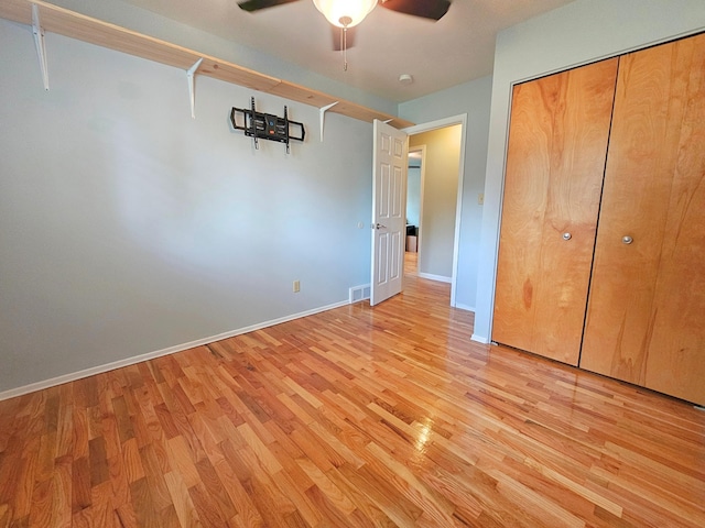 10040 S Reese Rd, Birch Run, MI 48415 - unfurnished bedroom with light wood-style flooring, baseboards, a closet, and ceiling fan