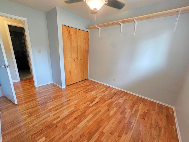 10040 S Reese Rd, Birch Run, MI 48415 - unfurnished bedroom featuring light wood-style flooring, baseboards, a closet, and a ceiling fan