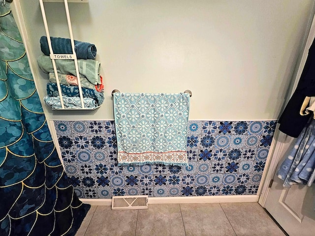 10040 S Reese Rd, Birch Run, MI 48415 - bathroom with a wainscoted wall, tile patterned flooring, and baseboards