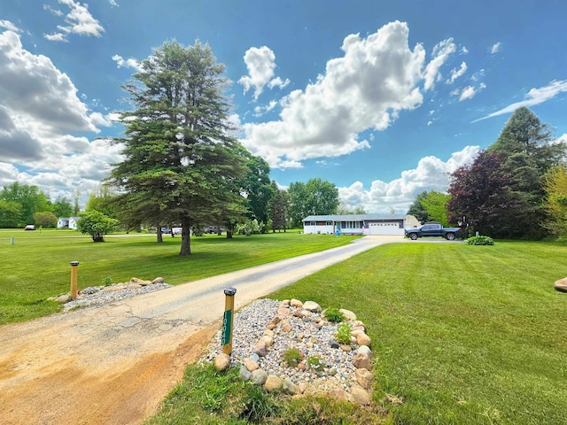 10040 S Reese Rd, Birch Run, MI 48415 - view of front facade featuring a front lawn, driveway, and an attached garage
