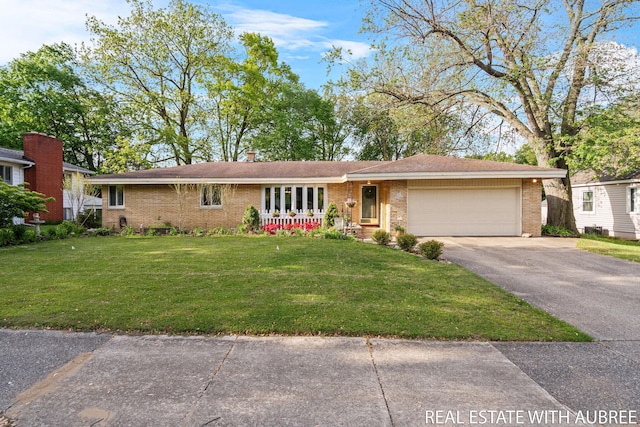 38 W 31st St, Holland, MI 49423 - ranch-style home with brick siding, asphalt driveway, a garage, and a front yard