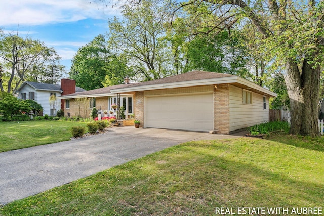38 W 31st St, Holland, MI 49423 - ranch-style house featuring brick siding, an attached garage, a front yard, and driveway
