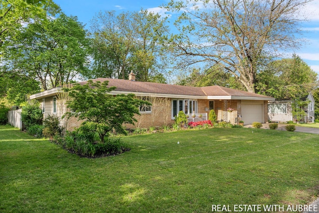 38 W 31st St, Holland, MI 49423 - ranch-style home featuring a garage, brick siding, a front yard, asphalt driveway, and a chimney