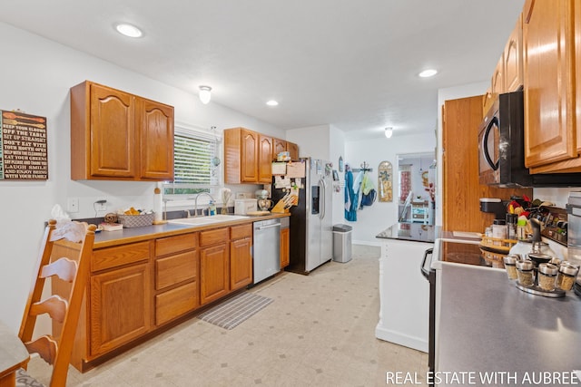 38 W 31st St, Holland, MI 49423 - kitchen with stainless steel appliances, a sink, light flooring, brown cabinetry, and recessed lighting