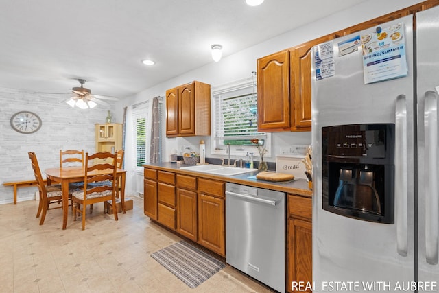 38 W 31st St, Holland, MI 49423 - kitchen with stainless steel appliances, a sink, a ceiling fan, brown cabinetry, and recessed lighting