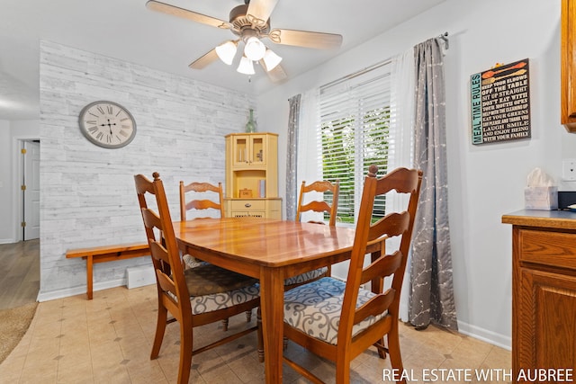 38 W 31st St, Holland, MI 49423 - dining room with an accent wall, a ceiling fan, and baseboards