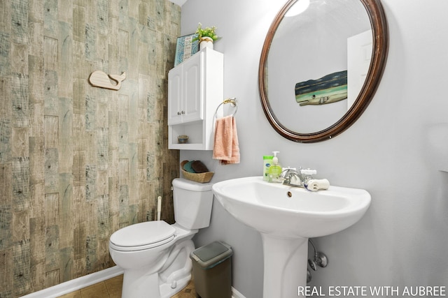 38 W 31st St, Holland, MI 49423 - bathroom with toilet, tile patterned floors, and a sink