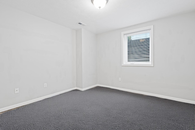 38 W 31st St, Holland, MI 49423 - unfurnished room featuring baseboards and dark colored carpet