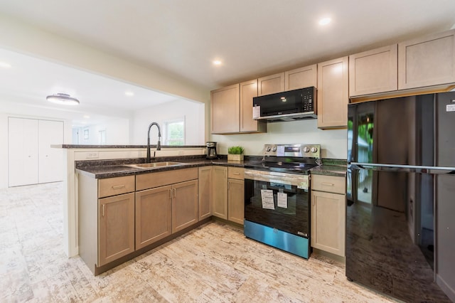 3687 111th Ave, Allegan, MI 49010 - kitchen featuring black appliances, a sink, a peninsula, recessed lighting, and dark stone counters