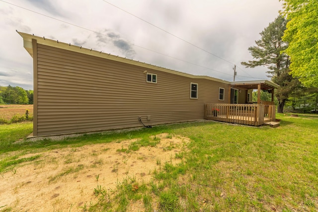 3687 111th Ave, Allegan, MI 49010 - rear view of property with a wooden deck and a lawn
