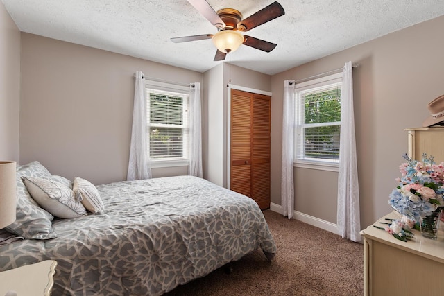 113 Greenleaf St, Onsted, MI 49265 - carpeted bedroom featuring multiple windows, a closet, baseboards, ceiling fan, and a textured ceiling