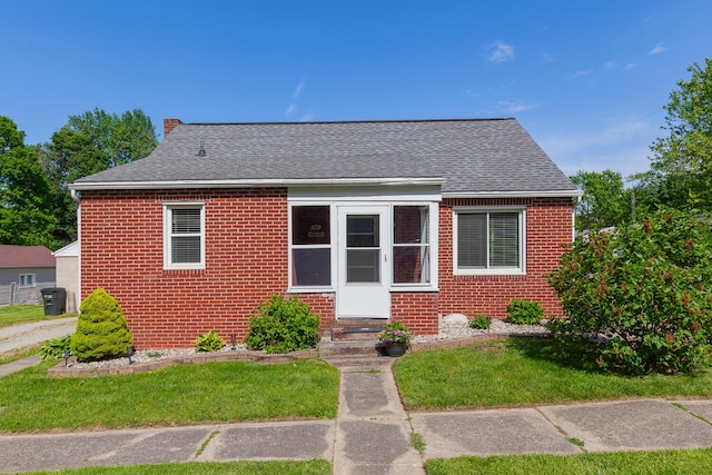 113 Greenleaf St, Onsted, MI 49265 - bungalow-style house with brick siding, a front yard, and roof with shingles