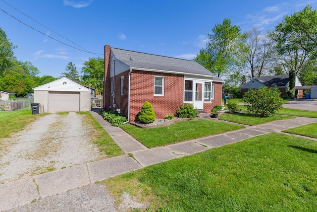 113 Greenleaf St, Onsted, MI 49265 - bungalow featuring an outdoor structure, a chimney, brick siding, a detached garage, and driveway