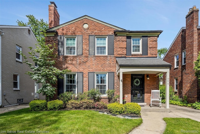 480 Fisher Rd, Grosse Pointe Farms, MI 48230 - view of front of property featuring brick siding, a chimney, a porch, and a front lawn