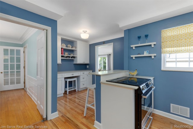 480 Fisher Rd, Grosse Pointe Farms, MI 48230 - kitchen featuring open shelves, black range with electric cooktop, white cabinets, light wood-type flooring, and light countertops