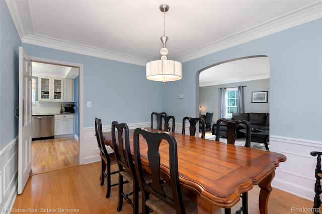 480 Fisher Rd, Grosse Pointe Farms, MI 48230 - dining space with arched walkways, wainscoting, ornamental molding, light wood finished floors, and a decorative wall