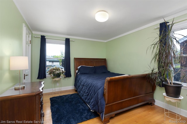 480 Fisher Rd, Grosse Pointe Farms, MI 48230 - bedroom with wood finished floors, baseboards, and crown molding
