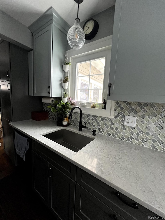 717 W 12 Mile Rd, Royal Oak, MI 48073 - kitchen featuring a sink, decorative backsplash, light stone countertops, and pendant lighting