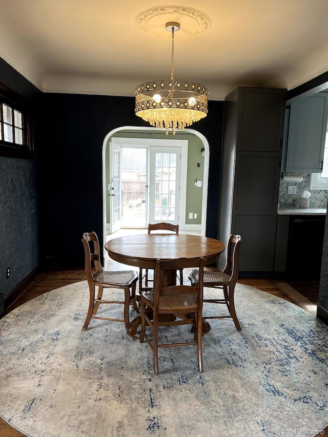 717 W 12 Mile Rd, Royal Oak, MI 48073 - dining space featuring arched walkways, a chandelier, wood finished floors, and baseboards