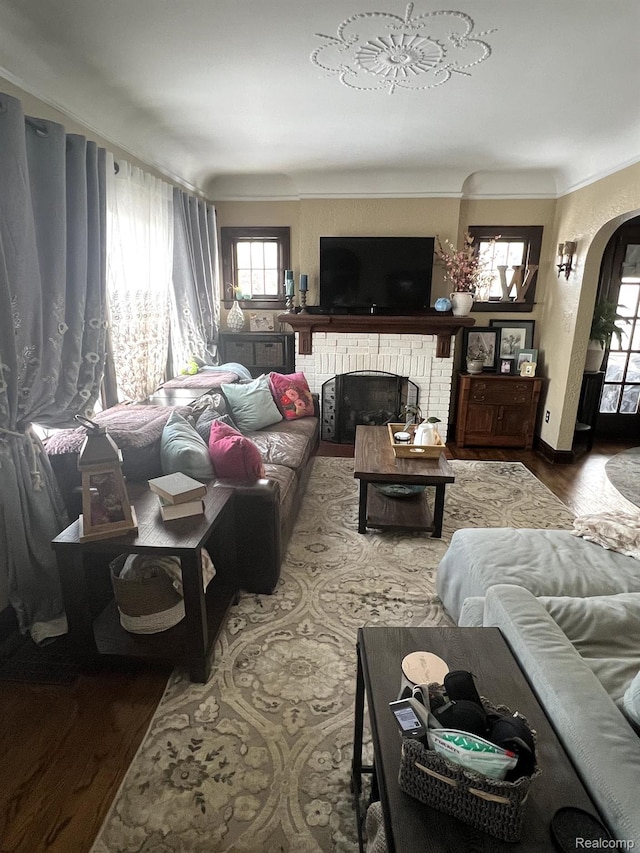 717 W 12 Mile Rd, Royal Oak, MI 48073 - living room with arched walkways, a fireplace, wood finished floors, and crown molding