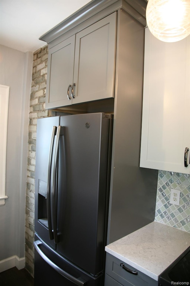 717 W 12 Mile Rd, Royal Oak, MI 48073 - kitchen with stainless steel fridge, gray cabinets, light stone counters, and backsplash