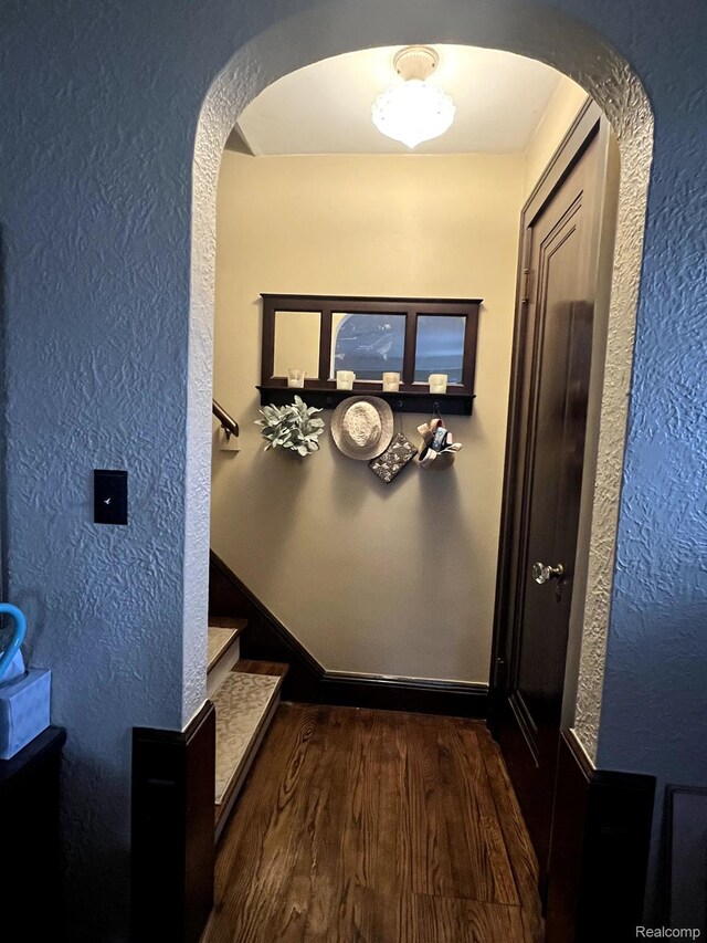 717 W 12 Mile Rd, Royal Oak, MI 48073 - hall with arched walkways, a textured wall, wood finished floors, and stairway