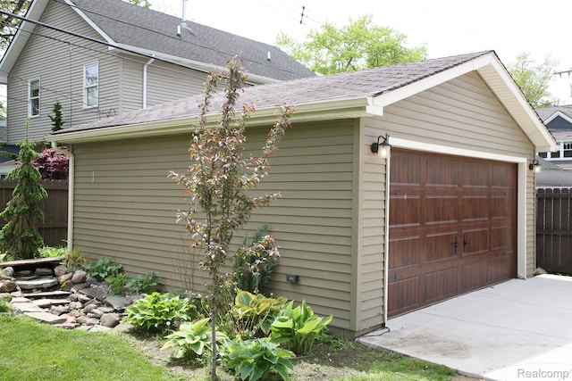 717 W 12 Mile Rd, Royal Oak, MI 48073 - view of property exterior with a garage, a shingled roof, and an outdoor structure