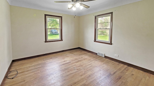 2127 E Coldwater Rd, Flint, MI 48505 - spare room with light wood-style floors, a ceiling fan, and baseboards