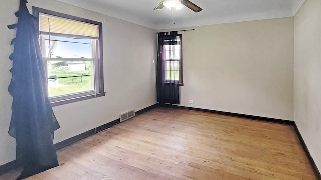 2127 E Coldwater Rd, Flint, MI 48505 - spare room with wood finished floors, baseboards, and ceiling fan