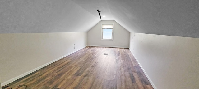 2127 E Coldwater Rd, Flint, MI 48505 - additional living space with wood finished floors, lofted ceiling, and baseboards