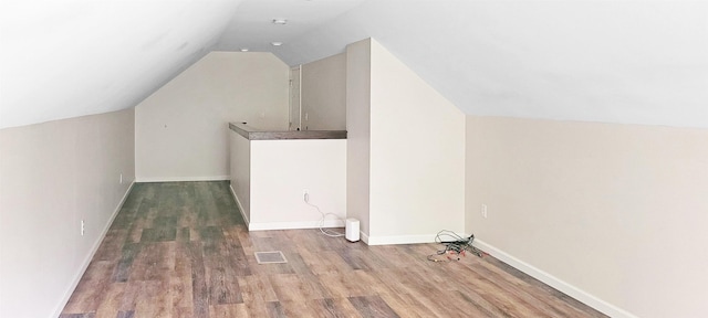 2127 E Coldwater Rd, Flint, MI 48505 - additional living space featuring lofted ceiling, wood finished floors, and baseboards