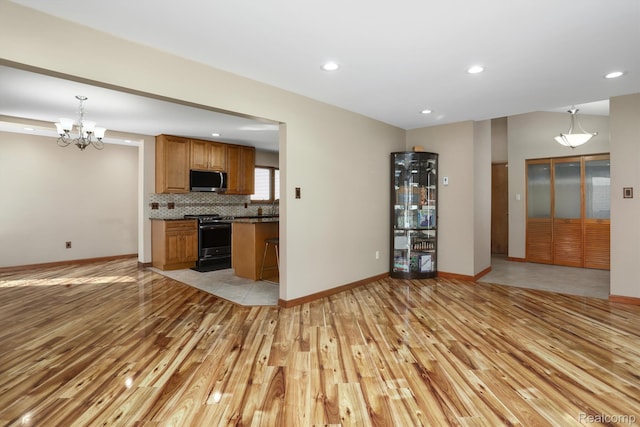 4173 Brandywyne Dr, Troy, MI 48098 - unfurnished living room featuring light wood-type flooring, a chandelier, baseboards, and recessed lighting