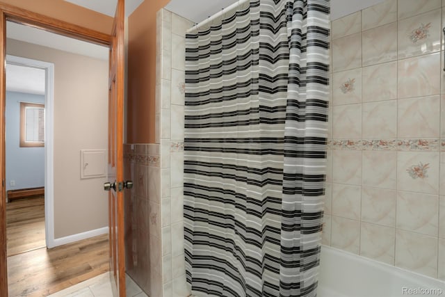 4173 Brandywyne Dr, Troy, MI 48098 - bathroom featuring wood finished floors, shower / bathtub combination with curtain, and baseboards