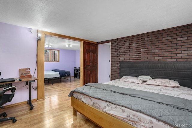 4173 Brandywyne Dr, Troy, MI 48098 - bedroom featuring light wood-style flooring, a textured ceiling, and baseboards