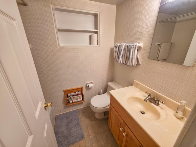 1352 Haughey Dr, Union City, MI 49094 - bathroom with tile walls, vanity, toilet, stone finish flooring, and a shower