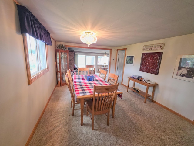 1352 Haughey Dr, Union City, MI 49094 - dining room with light colored carpet, a chandelier, and baseboards