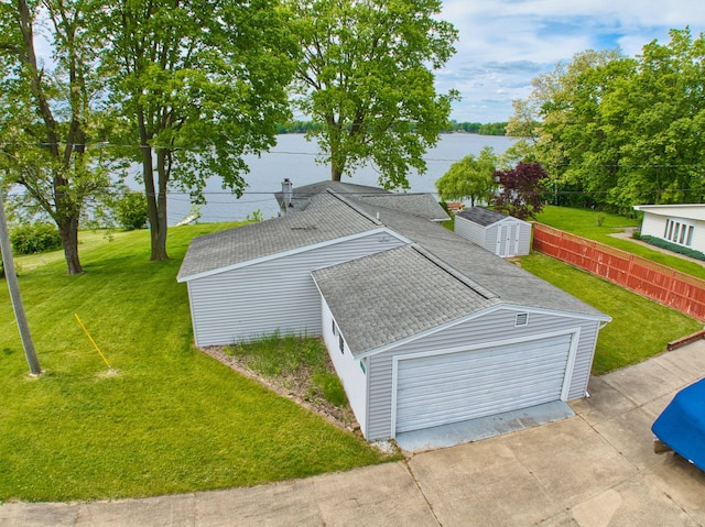 1352 Haughey Dr, Union City, MI 49094 - view of side of home with a shingled roof, a garage, and a water view