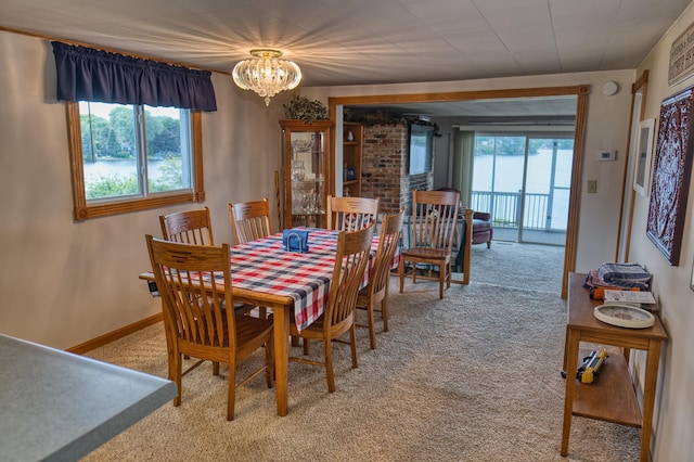 1352 Haughey Dr, Union City, MI 49094 - dining area with light carpet, a chandelier, and baseboards