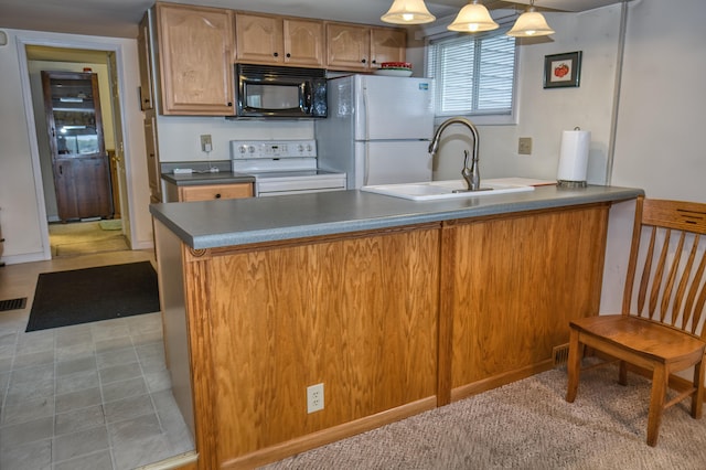 1352 Haughey Dr, Union City, MI 49094 - kitchen featuring white appliances, a sink, a peninsula, dark countertops, and decorative light fixtures